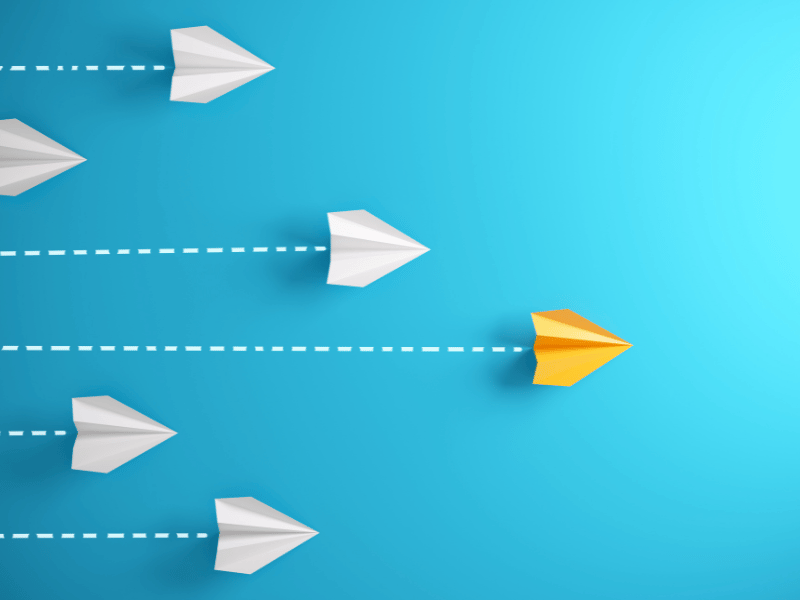 paper planes on blue background symbolizing leadership