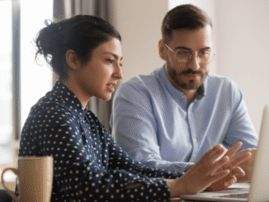 woman mentoring man in business setting