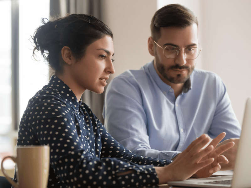 woman mentoring man in business setting